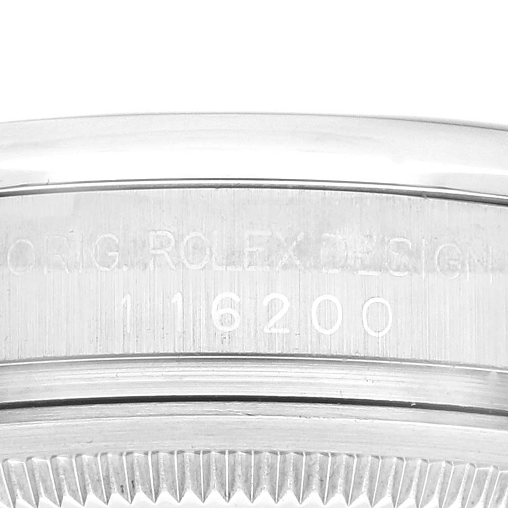 The image shows a close-up view of the serial number and engraved details on the side of a Rolex Datejust 116200 Men's Stainless Steel Blue Dial 116200 Men's Stainless Steel Blue Dial watch casing.