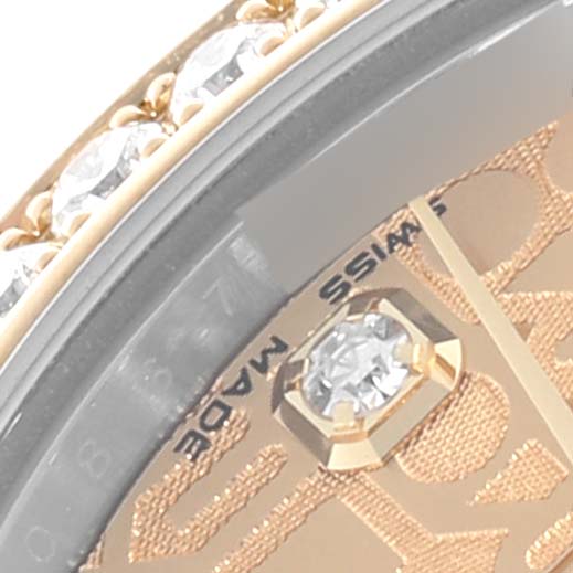 The image shows a close-up of a Rolex Mid-Size M178383-0008 Women's Steel and Gold (two tone) Champagne Dial M178383-0008 Women's Steel and Gold (two tone) Champagne Dial watch, highlighting the bezel, part of the dial, and diamond accents.
