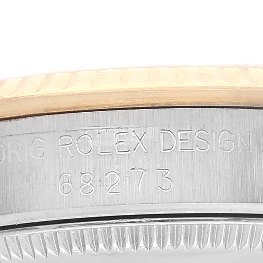The image shows a close-up of the model number engraving on the side of a Mid-Size Rolex watch case.