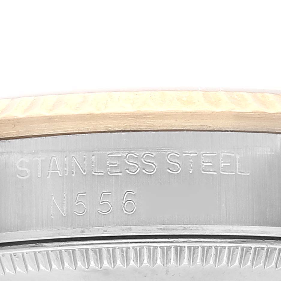 This image shows a close-up of the bezel and case edge of the Rolex Mid-Size 68273 Women
s Steel and Gold (two tone) Champagne Dial 68273 Women
s Steel and Gold (two tone) Champagne Dial watch, displaying the "STAINLESS STEEL" engraving.