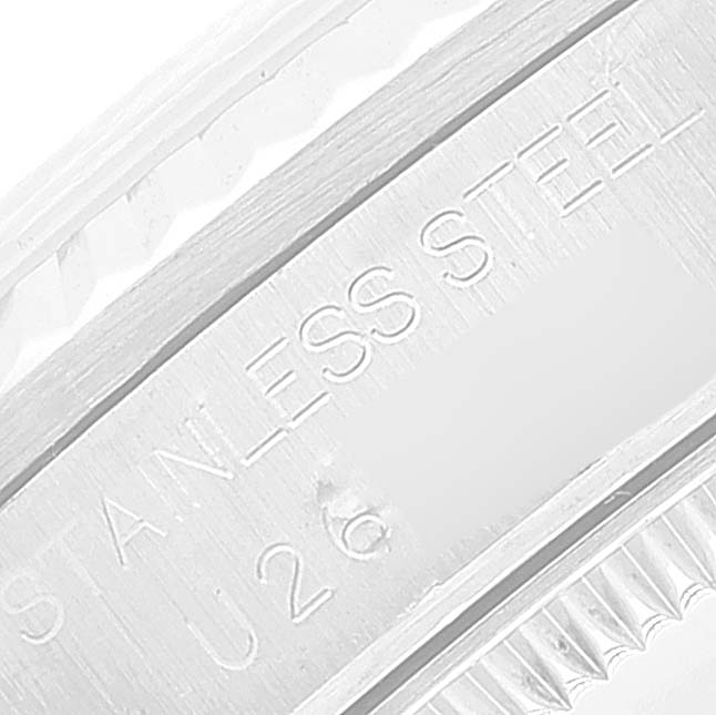 This image shows a close-up of the stainless steel rim and engraving on a Mid-Size Rolex watch.