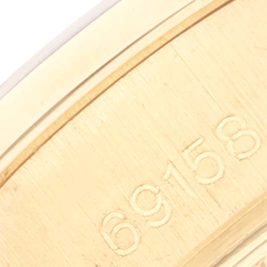 The image shows a close-up of the engraved serial number on a gold Rolex President 69158 Women
s Yellow Gold Champagne Dial 69158 Women
s Yellow Gold Champagne Dial model watch case.