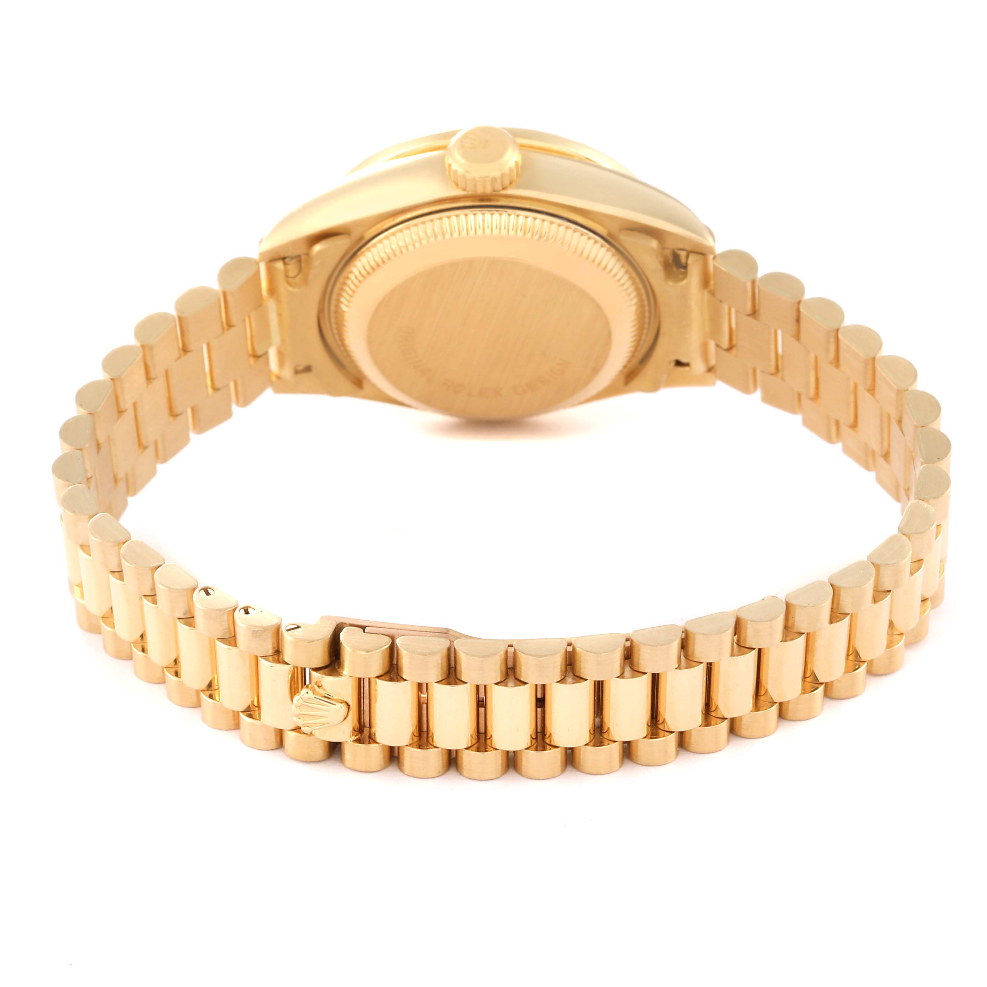 The image shows the backside of a golden Rolex President 69158 Women
s Yellow Gold Champagne Dial 69158 Women
s Yellow Gold Champagne Dial model watch, including its case back and bracelet.