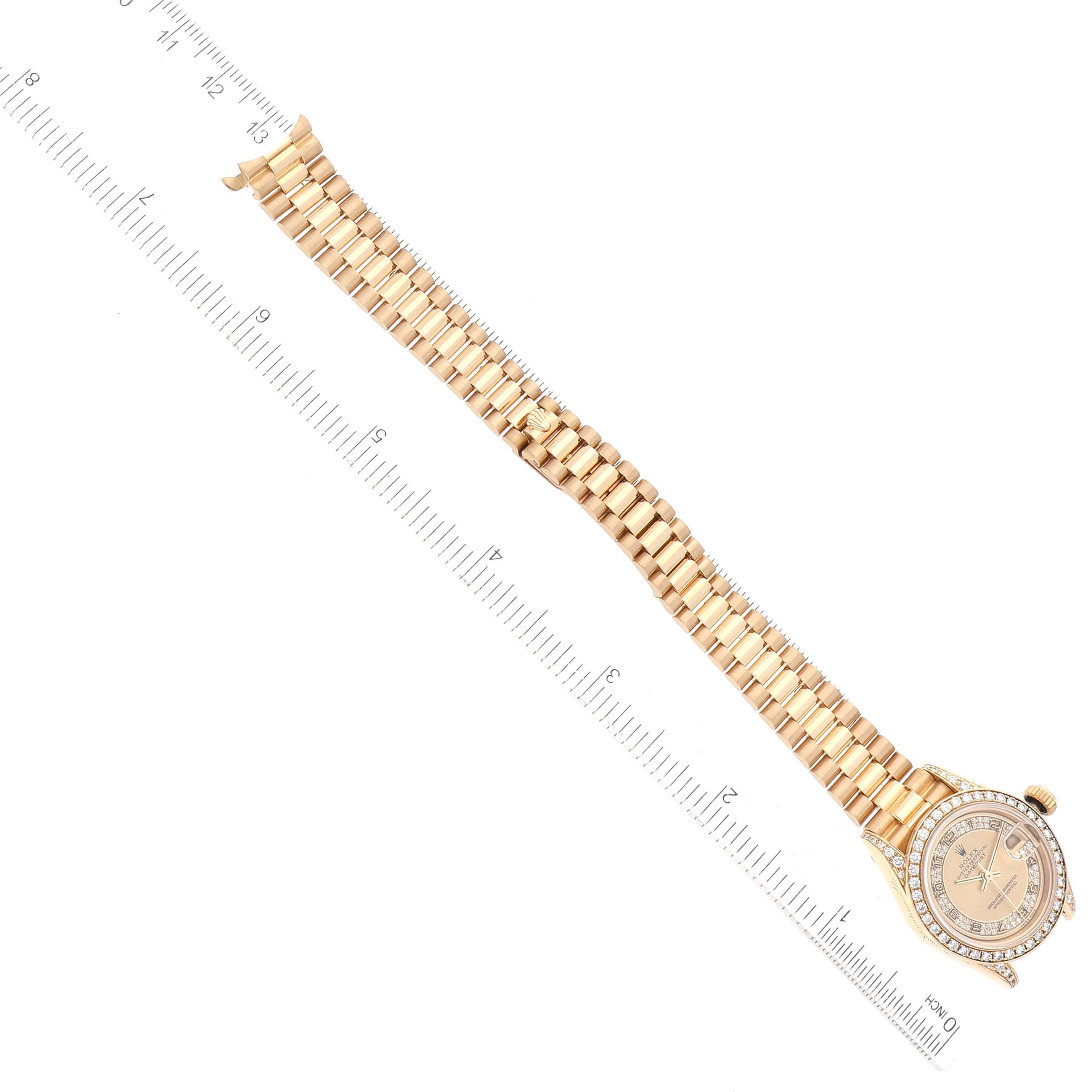 The image shows a Rolex President 69158 Women
s Yellow Gold Champagne Dial 69158 Women
s Yellow Gold Champagne Dial model watch laid out flat alongside a ruler, displaying the bracelet and watch face.