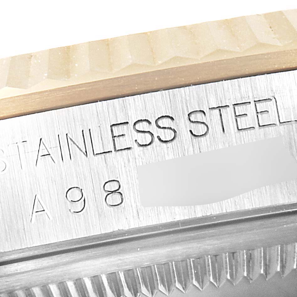 This close-up image shows the engraved text and part of the bezel of a Rolex Datejust 16233 Men's Steel and Gold (two tone) Champagne Dial 16233 Men's Steel and Gold (two tone) Champagne Dial watch.