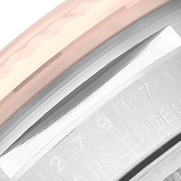 This close-up image of a Rolex Datejust 279171 Women's Stainless Steel Pink Dial 279171 Women's Stainless Steel Pink Dial watch shows the engraved case and part of the bezel.