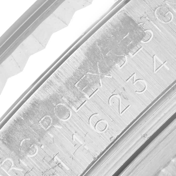 The image shows a close-up of the inner case and bezel of a Rolex Datejust 116234 Men
s Stainless Steel Black Dial 116234 Men
s Stainless Steel Black Dial, focusing on the engraved details.