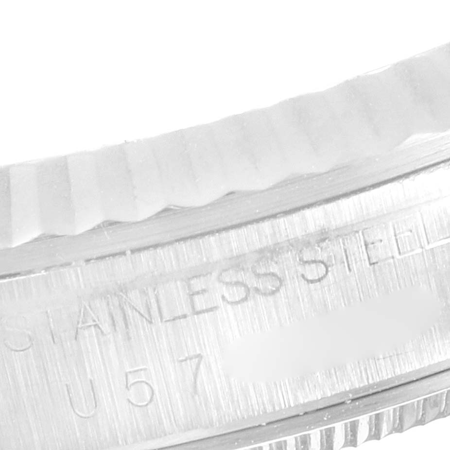 The image shows a close-up of the stainless steel, fluted bezel of a Rolex Datejust 16234 Men's Stainless Steel Silver Dial 16234 Men's Stainless Steel Silver Dial watch.