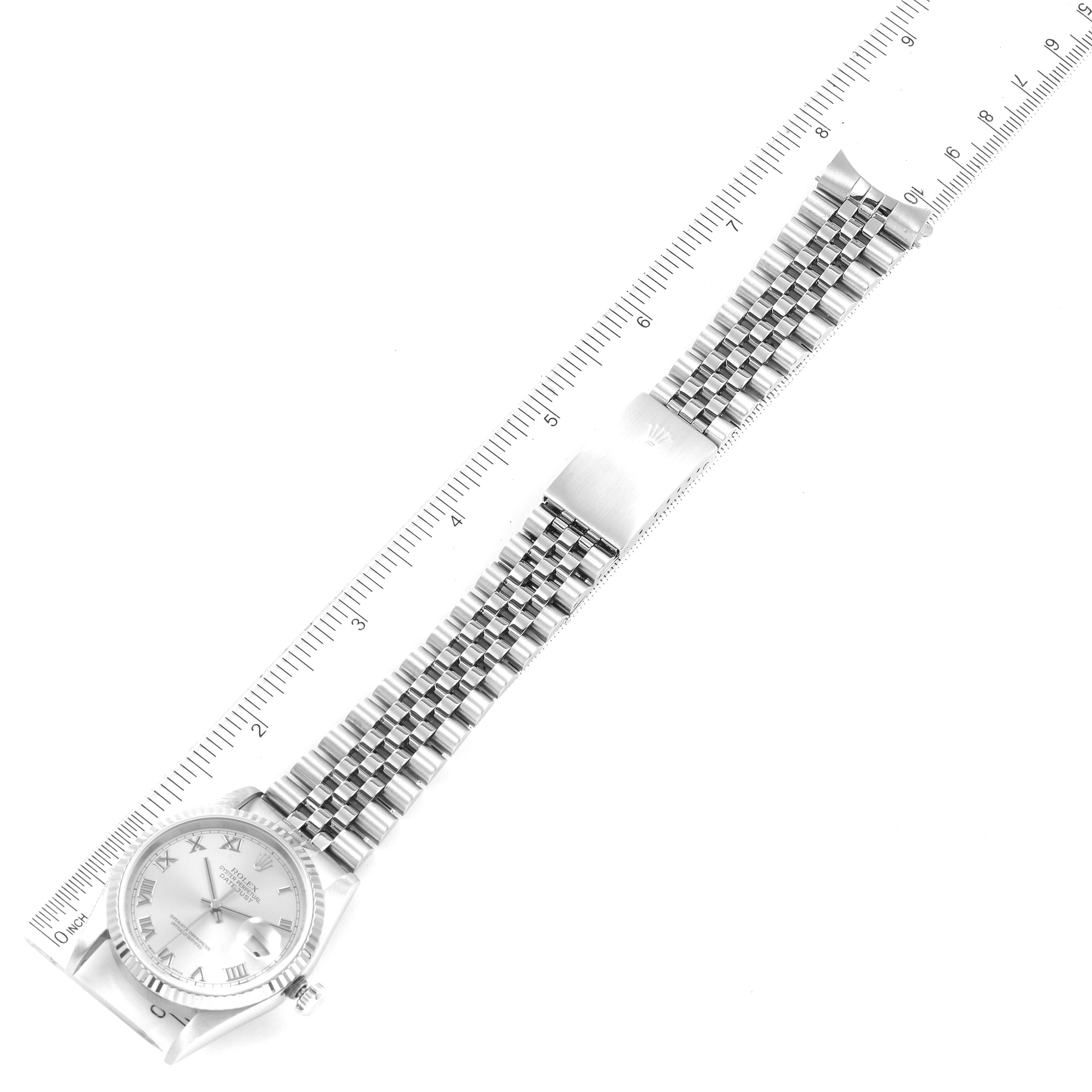 The image shows an overhead view of the Rolex Datejust 16234 Men's Stainless Steel Silver Dial 16234 Men's Stainless Steel Silver Dial watch, focusing on its face and bracelet with a ruler for scale.