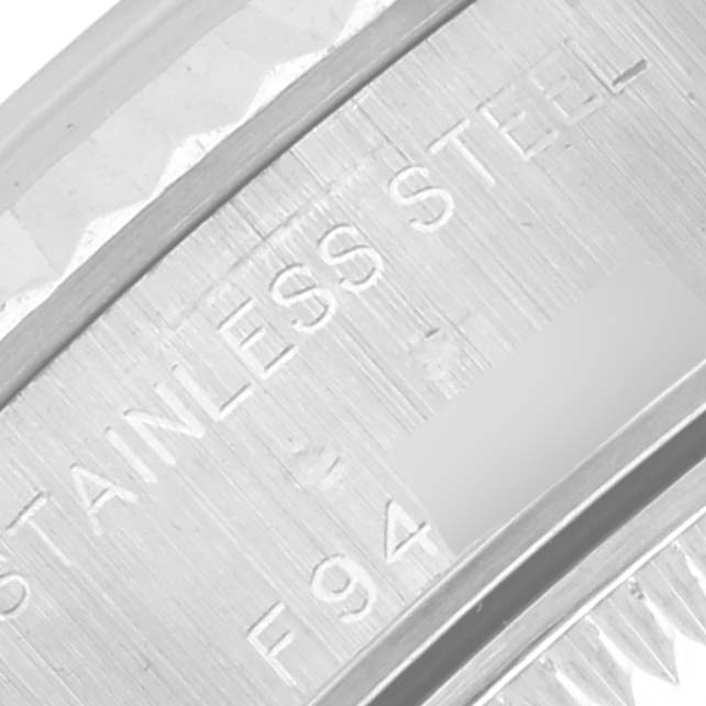 The image shows a close-up of the Rolex Datejust 79174 Women's Stainless Steel Mother of Pearl Dial 79174 Women's Stainless Steel Mother of Pearl Dial model's stainless steel case side with engraved text.