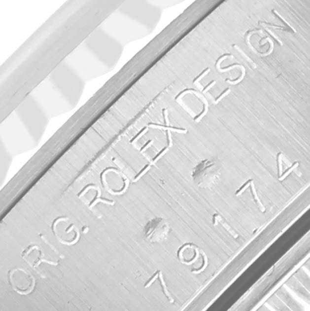 The image shows a close-up of the side engraving on a Rolex Datejust 79174 Women's Stainless Steel Mother of Pearl Dial 79174 Women's Stainless Steel Mother of Pearl Dial watch case.