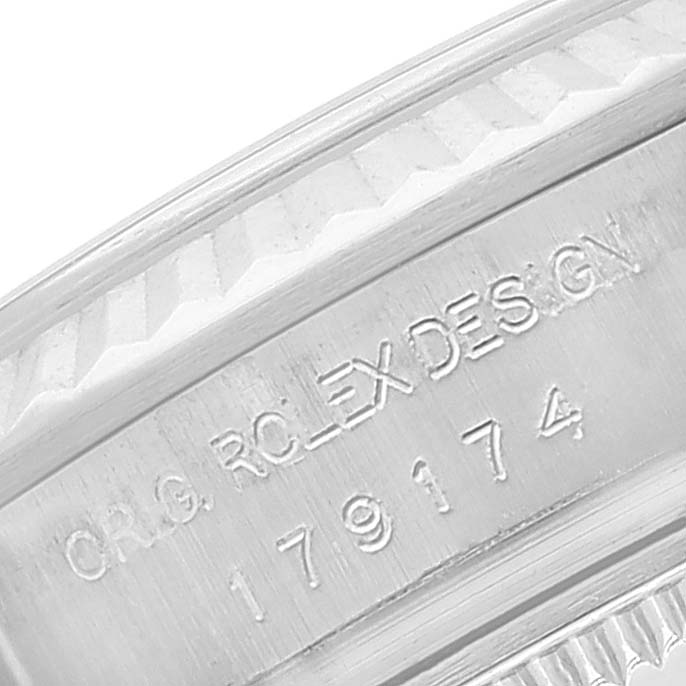 This is a close-up of the inner side of the bezel and case of a Rolex Datejust 179174 Women's Stainless Steel Silver Dial 179174 Women's Stainless Steel Silver Dial, showing the engraved serial number.