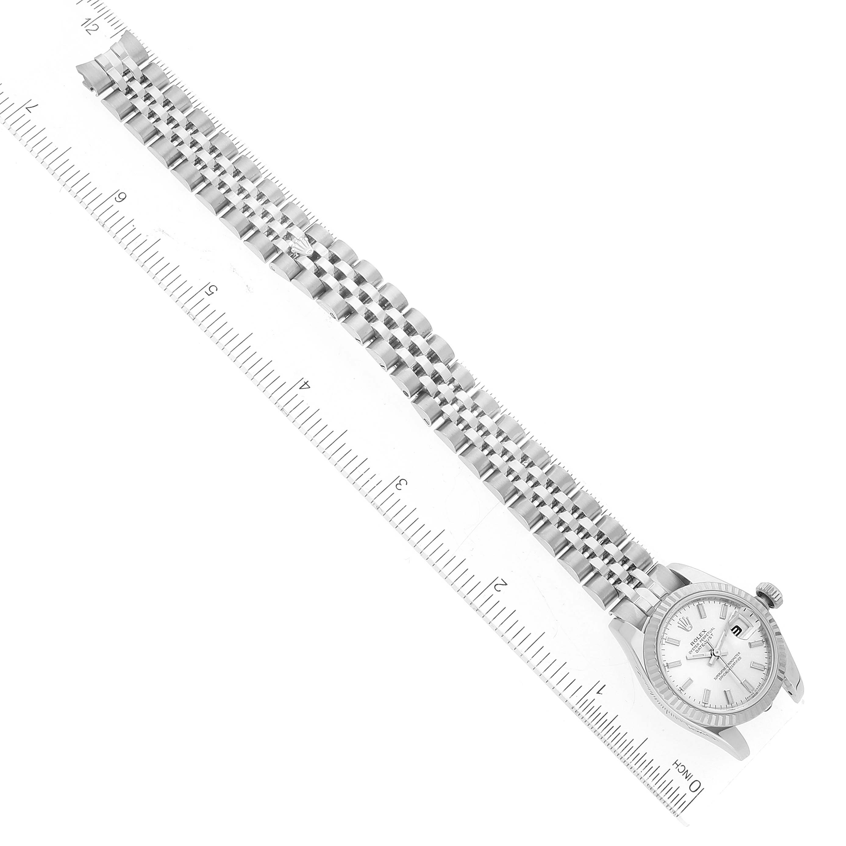 The image shows a Rolex Datejust 179174 Women's Stainless Steel Silver Dial 179174 Women's Stainless Steel Silver Dial watch laid flat alongside a ruler, displaying the watch face and bracelet.