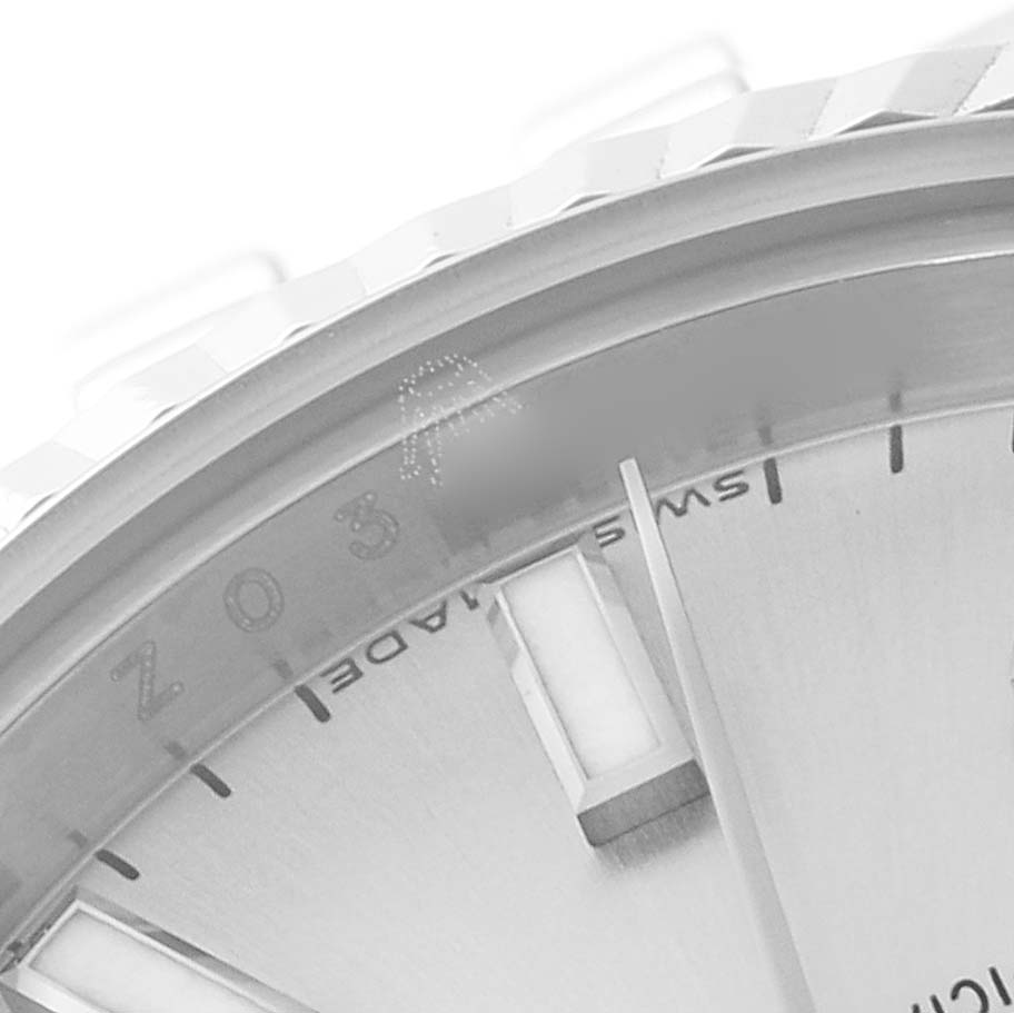 This close-up image shows part of the dial and bezel of a Rolex Datejust 179174 Women's Stainless Steel Silver Dial 179174 Women's Stainless Steel Silver Dial watch at an angled view.