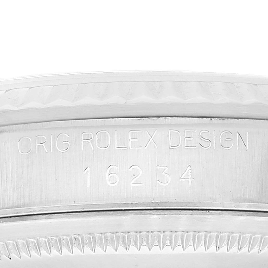 The image shows a close-up of the side of a Rolex Datejust 16234 Men's Stainless Steel Silver Dial 16234 Men's Stainless Steel Silver Dial watch, highlighting the engraving and part of the fluted bezel.