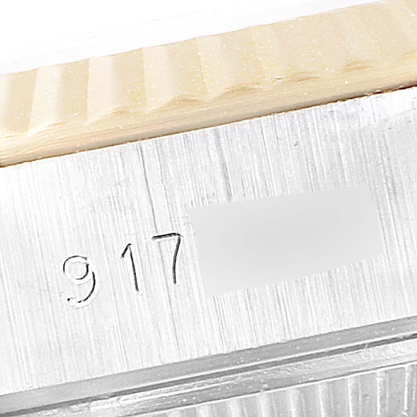 The image captures a close-up of the bezel and serial number on the case side of a Rolex Datejust 69173 Women's Steel and Gold (two tone) Black Dial 69173 Women's Steel and Gold (two tone) Black Dial watch.