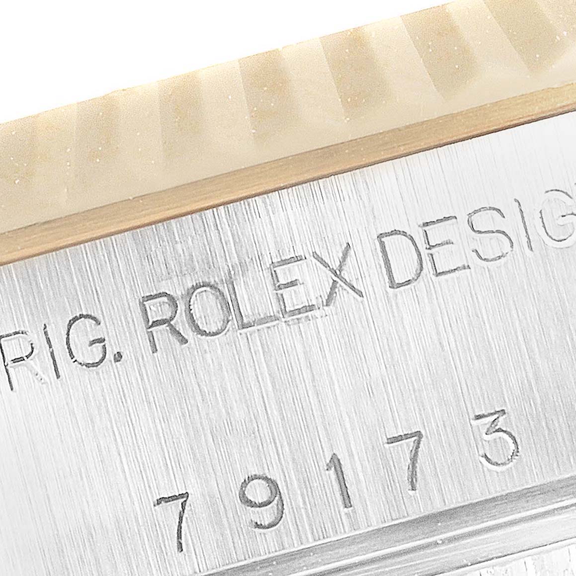 The image shows a close-up of the case side of a Rolex Datejust 79173 Women's Steel and Gold (two tone) Blue Dial 79173 Women's Steel and Gold (two tone) Blue Dial, featuring the model number and the words "ROLEX DESIGN."