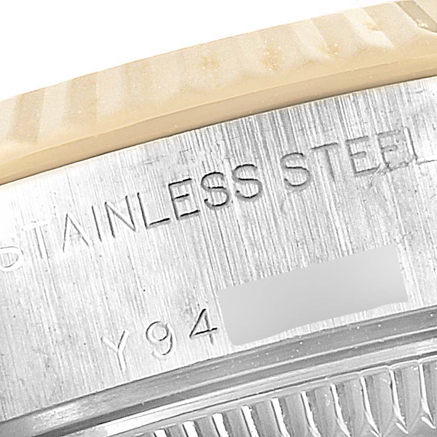 The image shows an angled close-up view of the case back of a Rolex Datejust 79173 Women's Steel and Gold (two tone) Blue Dial 79173 Women's Steel and Gold (two tone) Blue Dial watch, featuring the engraved model details and serial number.