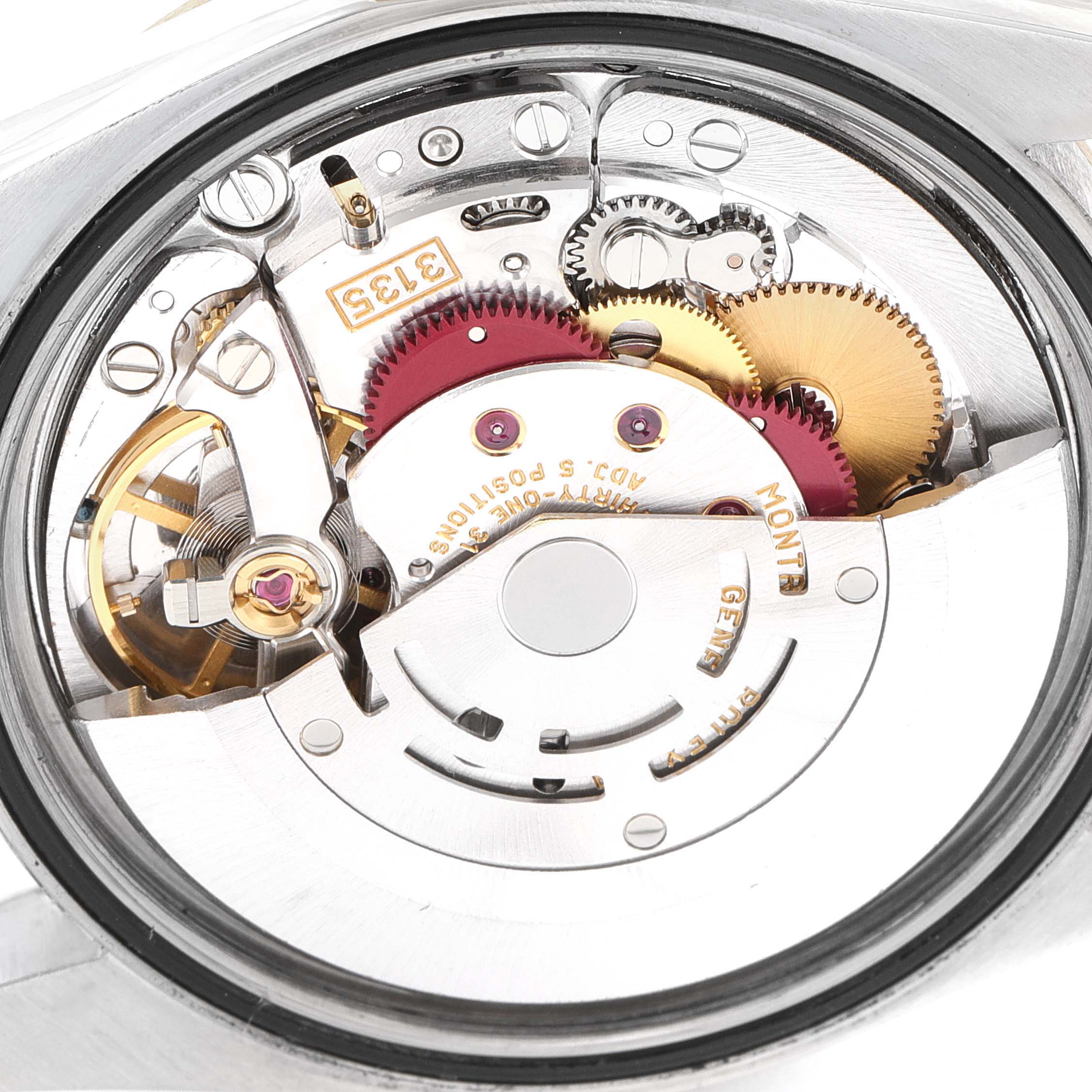 The image shows the movement mechanism of a Rolex Datejust 16233 Men
s Steel and Gold (two tone) Champagne Dial watch from the back, highlighting gears and components.