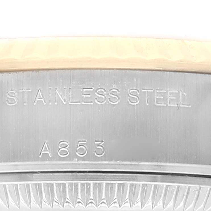 The image shows the engraved side detail of the bezel on a Rolex Datejust 79173 Women's Steel and Gold (two tone) Champagne Dial 79173 Women's Steel and Gold (two tone) Champagne Dial watch made of stainless steel.