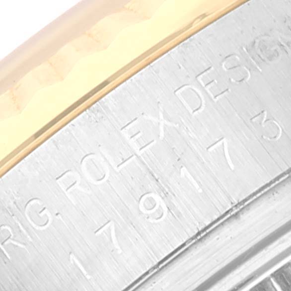 The image shows a close-up of the engraved bezel and part of the case of a Rolex Datejust 179173 Women's Steel and Gold (two tone) Pink Dial 179173 Women's Steel and Gold (two tone) Pink Dial watch.