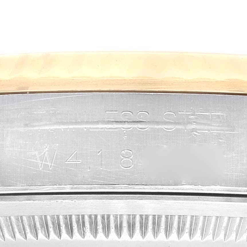 The image shows a close-up view of the side engraving and the fluted bezel of a Rolex Datejust 16233 Men's Steel and Gold (two tone) Champagne Dial 16233 Men's Steel and Gold (two tone) Champagne Dial watch.