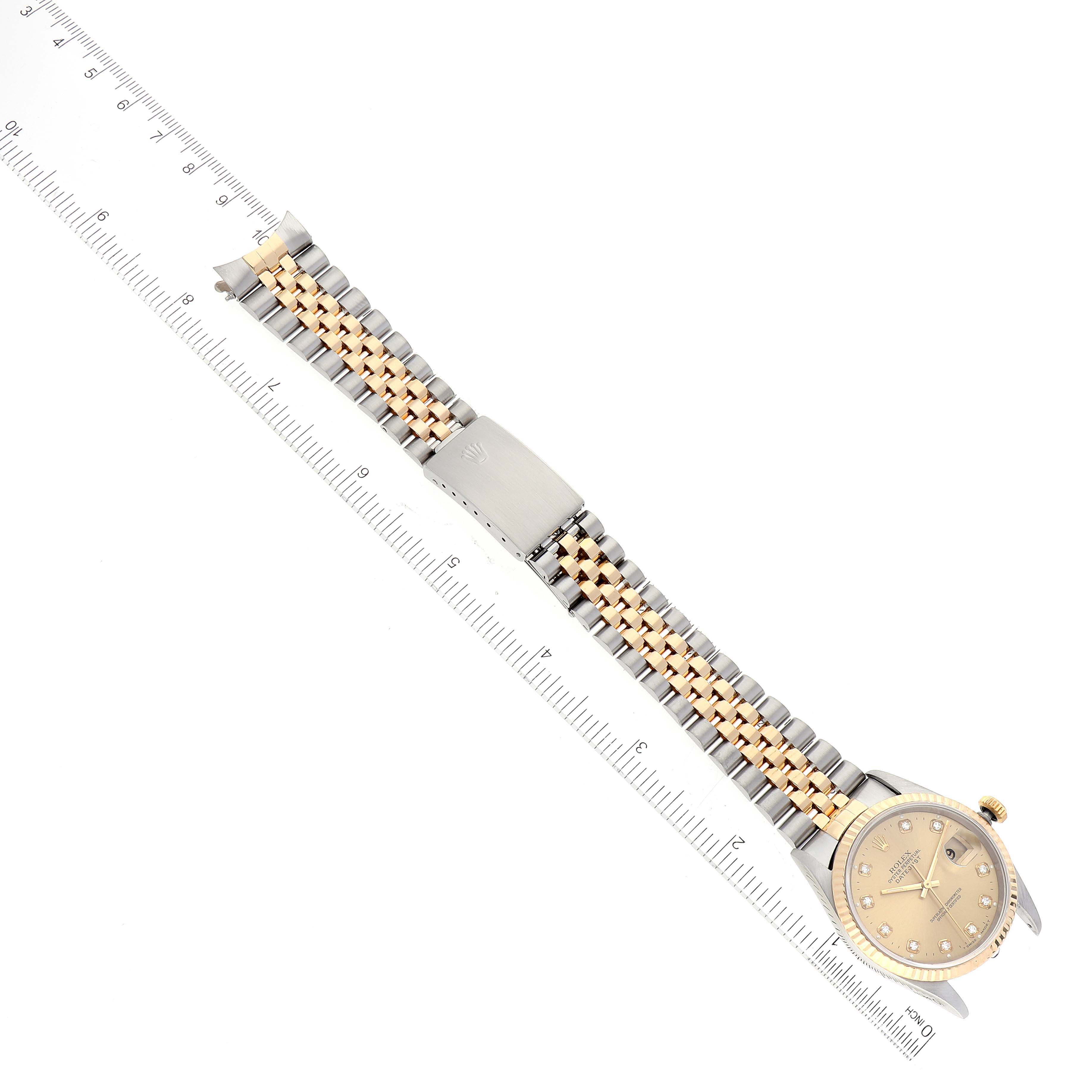 The image shows a Rolex Datejust 16233 Men's Steel and Gold (two tone) Champagne Dial 16233 Men's Steel and Gold (two tone) Champagne Dial watch laid flat, viewed from the top, with a measuring ruler next to it.