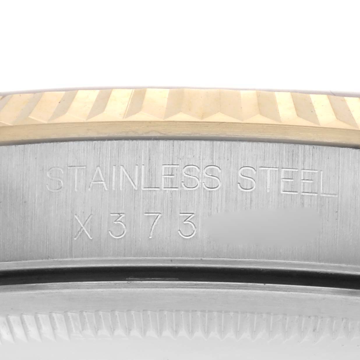 The image shows a close-up of the Rolex Datejust 16233 Men's Steel and Gold (two tone) Champagne Dial 16233 Men's Steel and Gold (two tone) Champagne Dial watch's stainless steel case side and fluted bezel.