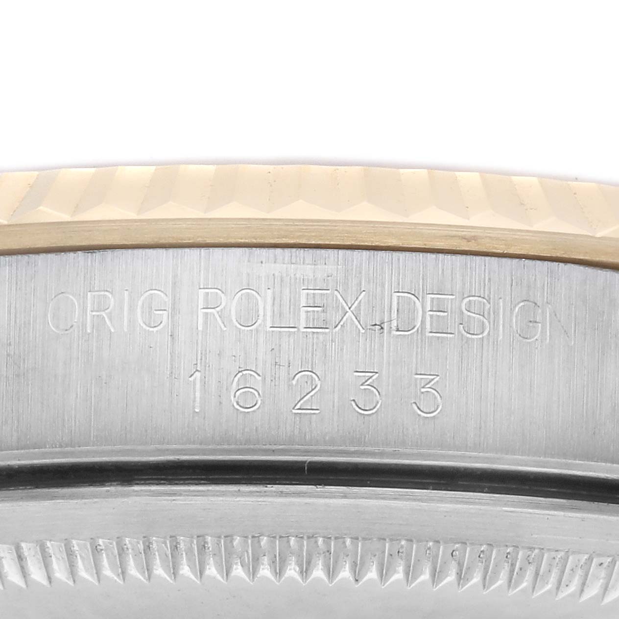 The image shows a close-up of the bezel and case side of a Rolex Datejust 16233 Men's Steel and Gold (two tone) Champagne Dial 16233 Men's Steel and Gold (two tone) Champagne Dial, highlighting engraved text.