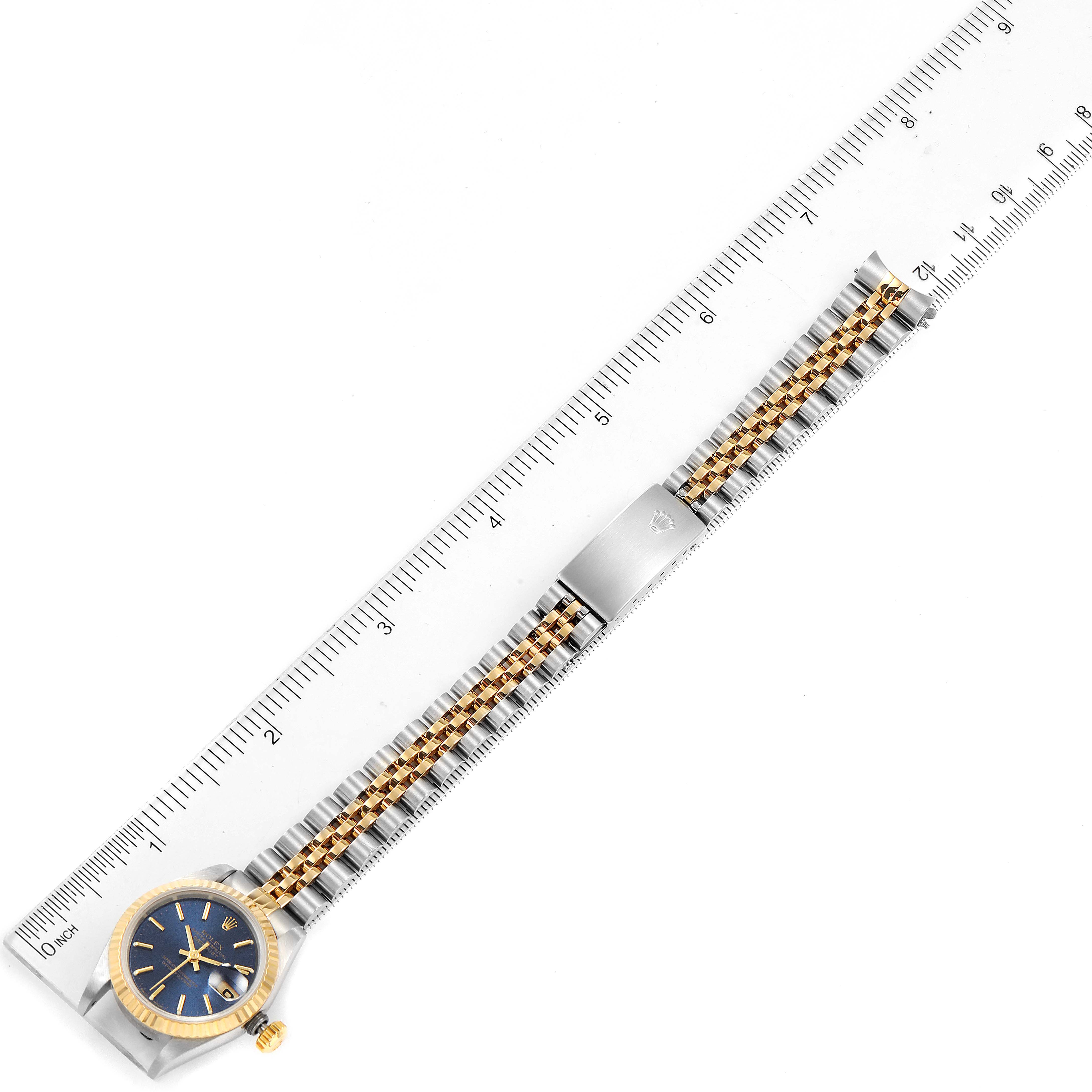 The image shows a full view of a Rolex Datejust 69173 Women's Steel and Gold (two tone) Blue Dial 69173 Women's Steel and Gold (two tone) Blue Dial watch laid flat next to a ruler for scale.