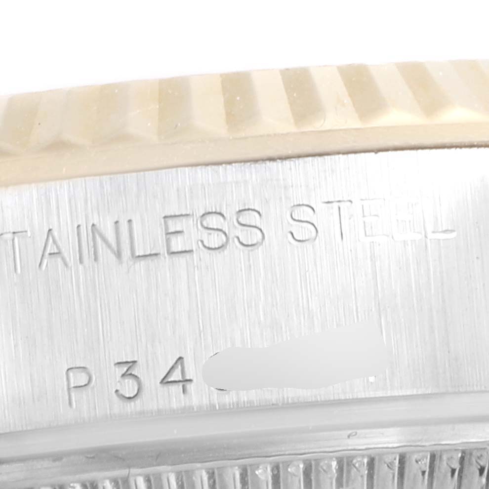 This image shows a close-up of the side of a Rolex Datejust 79173 Women's Steel and Gold (two tone) Mother of Pearl Dial 79173 Women's Steel and Gold (two tone) Mother of Pearl Dial watch, featuring the stainless steel engraving and serial number.