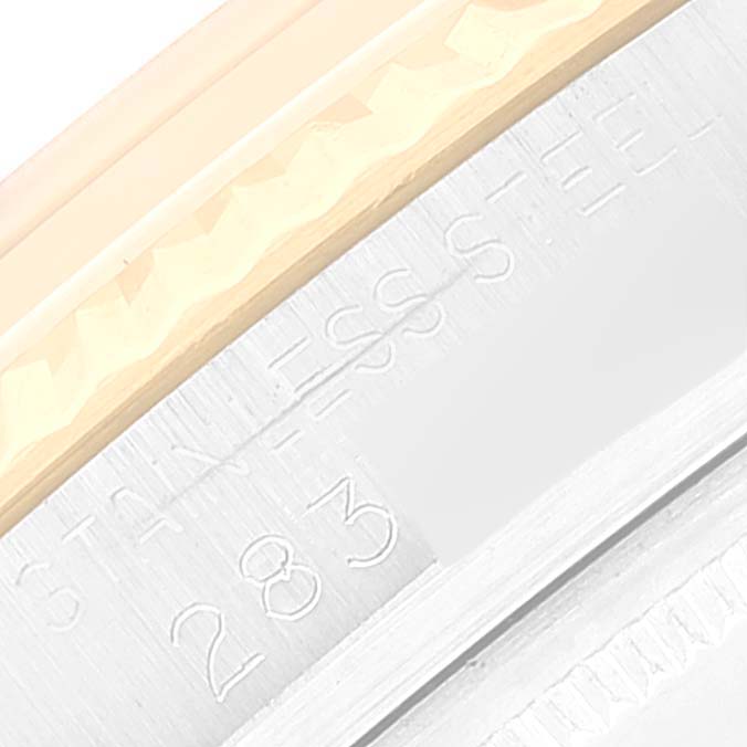 This close-up image shows the side of a Rolex Vintage Collection 1601 Men
s Steel and Gold (two tone) Silver Dial 1601 Men
s Steel and Gold (two tone) Silver Dial model, highlighting the edge of the bezel and part of the stainless steel case.