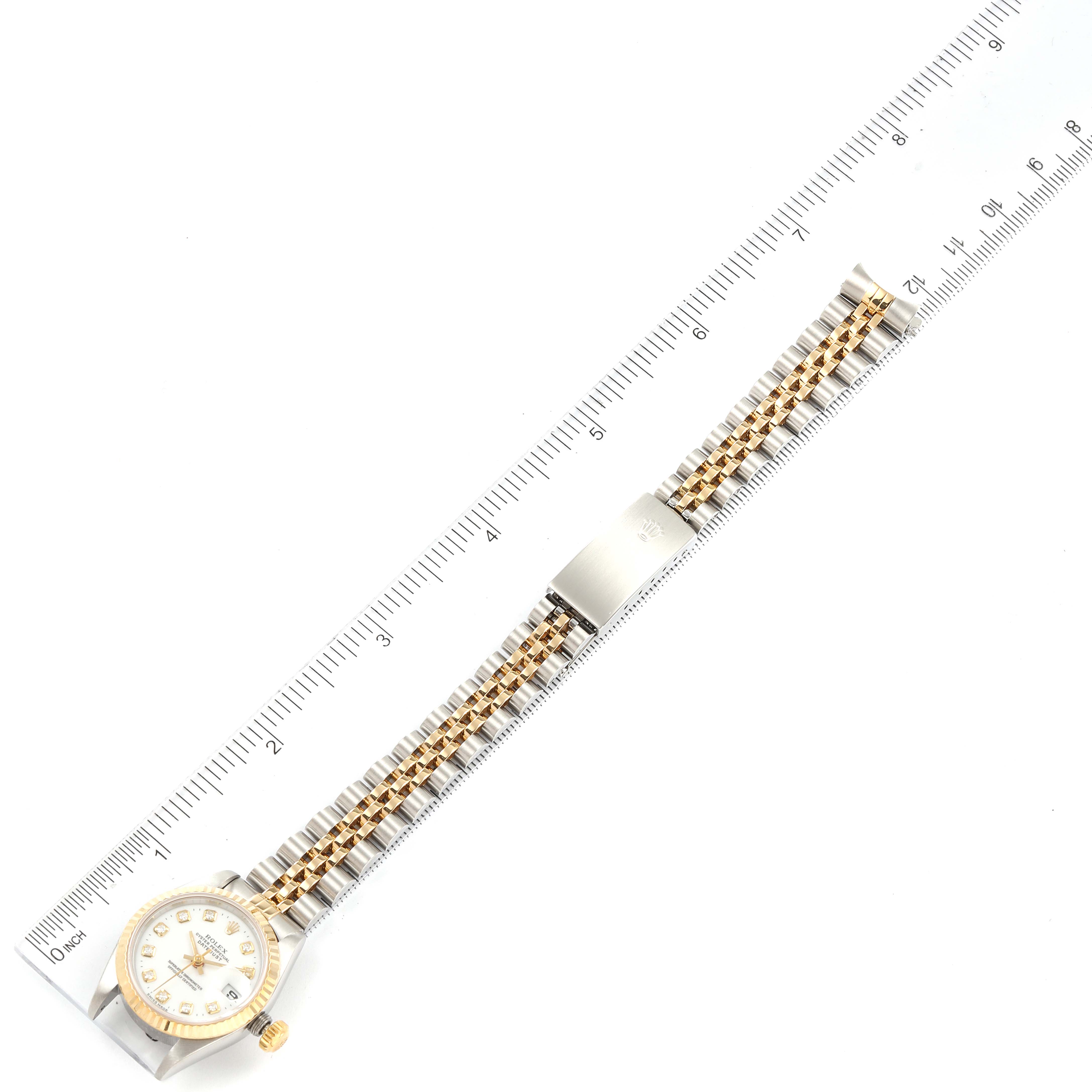 The image shows a top-down view of the Rolex Datejust 69173 Women's Steel and Gold (two tone) White Dial 69173 Women's Steel and Gold (two tone) White Dial watch placed alongside a ruler.