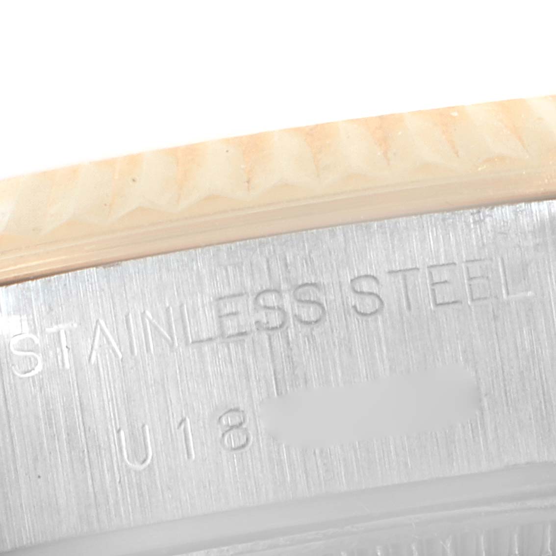 This is a close-up of the stainless steel part of a Rolex Datejust 69173 Women's Steel and Gold (two tone) White Dial 69173 Women's Steel and Gold (two tone) White Dial watch, showing the engraved text and part of the bezel.