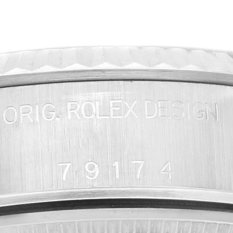 This image shows a close-up of the engraved case side of a Rolex Datejust 79174 Women's Stainless Steel Pink Dial 79174 Women's Stainless Steel Pink Dial watch.
