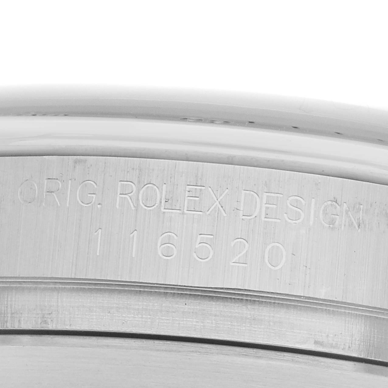 The image shows the side view of the Rolex Daytona 116520 Men's Stainless Steel Black Dial watch's case, highlighting the engraving with the model number.