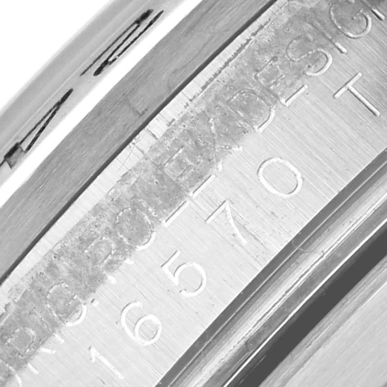 The image shows a close-up of the engraved bezel edge of the Rolex Explorer 16570T Men
s Stainless Steel Black Dial 16570T Men
s Stainless Steel Black Dial model.