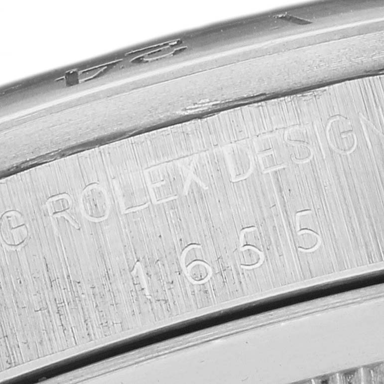 This close-up image showcases the model number and "ROLEX DESIGN" engraving on the case of a Vintage Collection Rolex watch.
