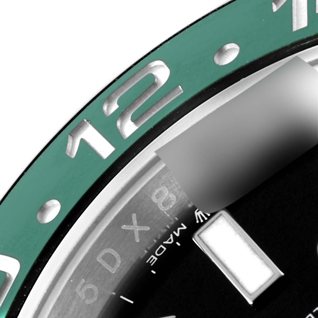 Close-up of the Rolex GMT-Master 126720VTNR-0001 Men
s Stainless Steel Black Dial 126720VTNR-0001 Men
s Stainless Steel Black Dial bezel showing the 12-hour marker and part of the dial with an hour marker.