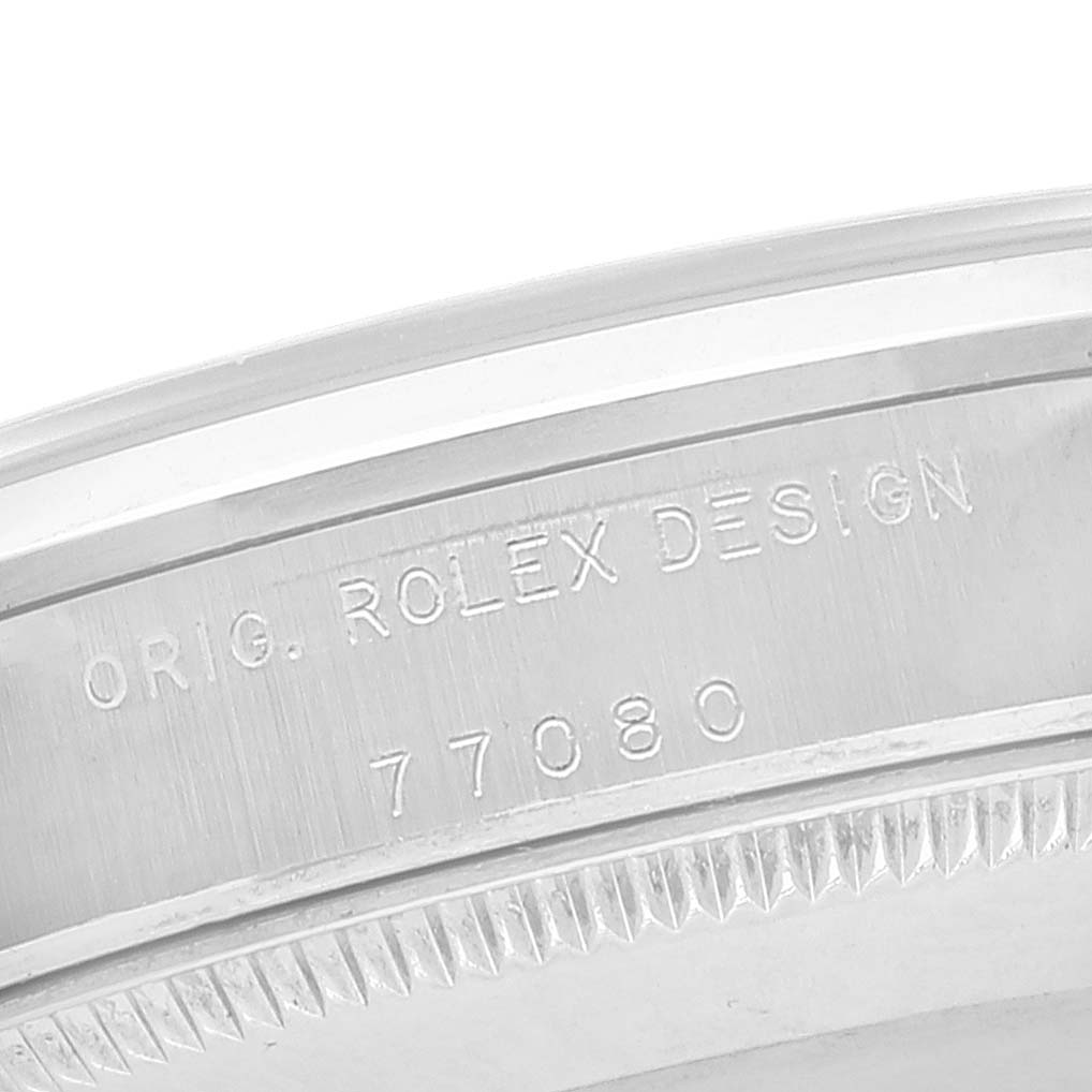 This image shows a close-up of the case back engraving on a mid-size Rolex watch, revealing the model number and "Rolex Design" inscription.