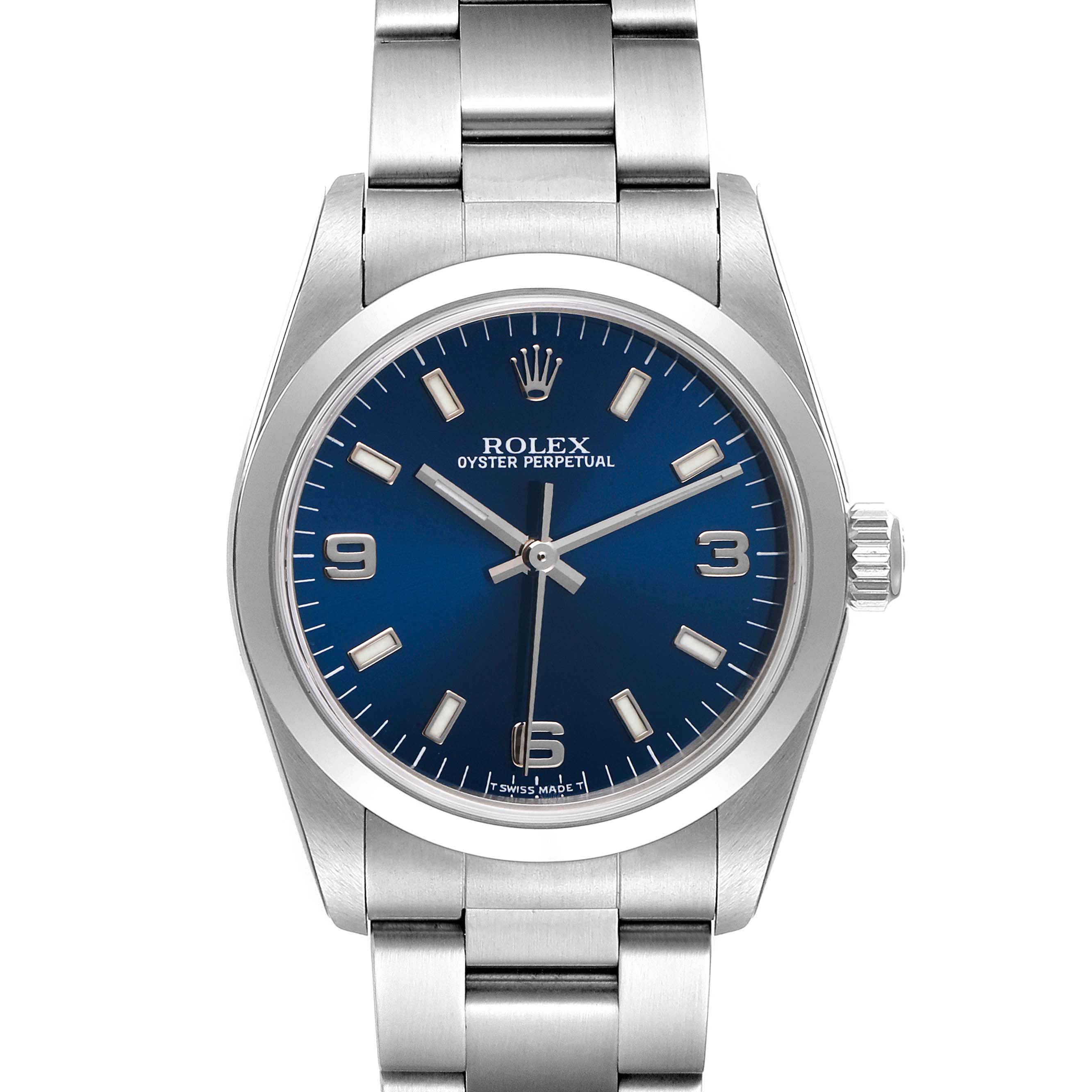The image shows a front view of the Rolex Oyster Perpetual Mid-Size watch, displaying its blue dial, bezel, and part of the bracelet.