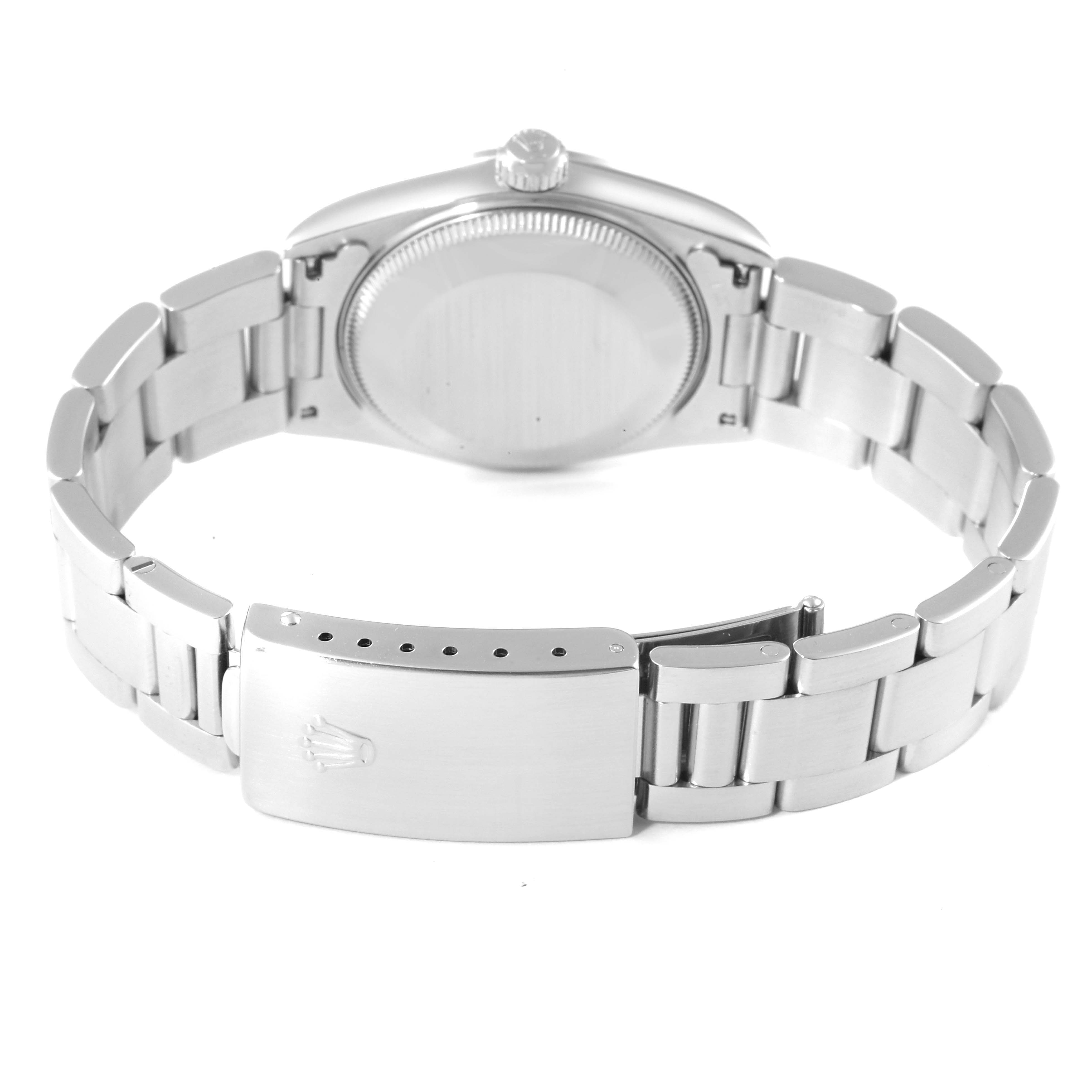 This image shows the backside of a Mid-Size Rolex watch, highlighting the case back, crown, and Oyster bracelet with the clasp.