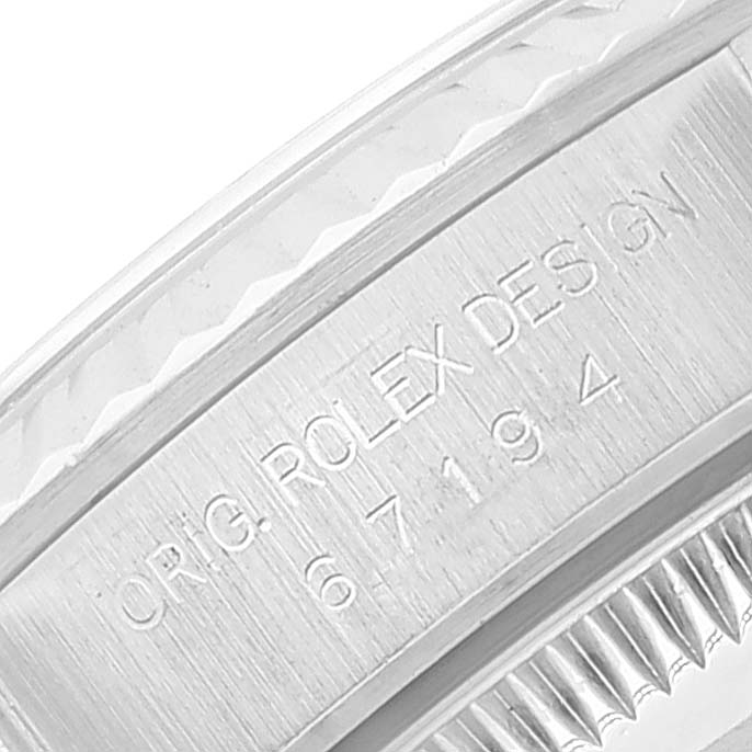 This image shows a close-up of the engraved case edge on a Rolex Oyster Perpetual 67194 Women
s Stainless Steel Silver Dial 67194 Women
s Stainless Steel Silver Dial watch.
