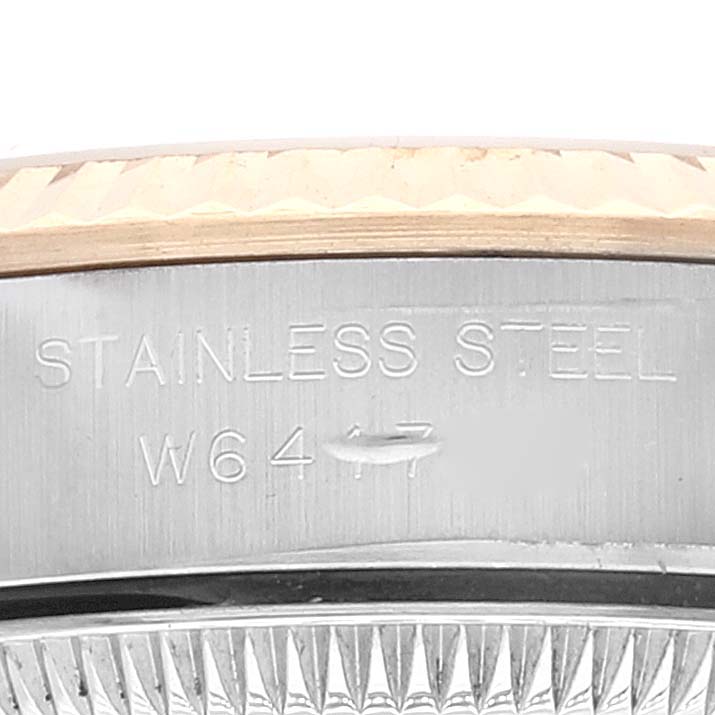 The image shows an up-close view of the case edge and part of the bezel of a Rolex Oyster Perpetual 67193 Women's Steel and Gold (two tone) Champagne Dial 67193 Women's Steel and Gold (two tone) Champagne Dial watch, highlighting the "Stainless Steel" engraving.