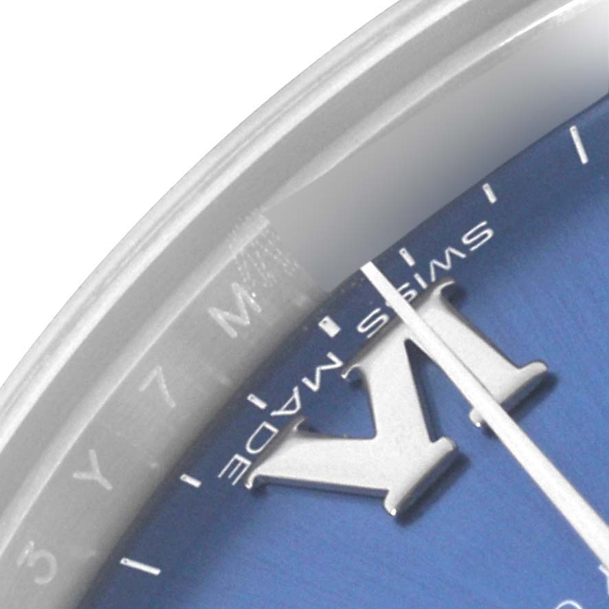 The image shows a close-up of the dial and bezel of a Rolex Mid-Size 177200 Women's Stainless Steel Blue Dial 177200 Women's Stainless Steel Blue Dial watch, highlighting the Roman numeral and "Swiss Made" text.