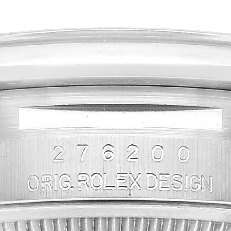 The image shows a close-up of the case back edge of a Rolex Oyster Perpetual 276200 Women's Stainless Steel Blue Dial 276200 Women's Stainless Steel Blue Dial with its model number and "ORIG. ROLEX DESIGN" engraving.