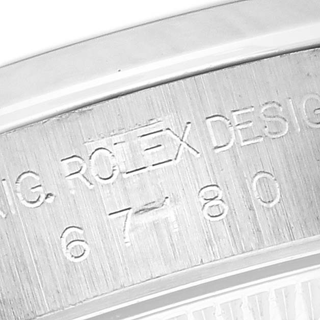 The image shows the engraved side of the bezel or case of a Rolex Oyster Perpetual 67180 Women's Stainless Steel Pink Dial 67180 Women's Stainless Steel Pink Dial watch.