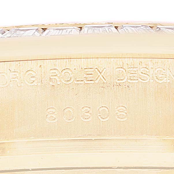 This close-up image shows the engraved serial number and part of the bezel on a Rolex Pearlmaster 80308 Women's Yellow Gold Mother of Pearl Dial 80308 Women's Yellow Gold Mother of Pearl Dial watch.