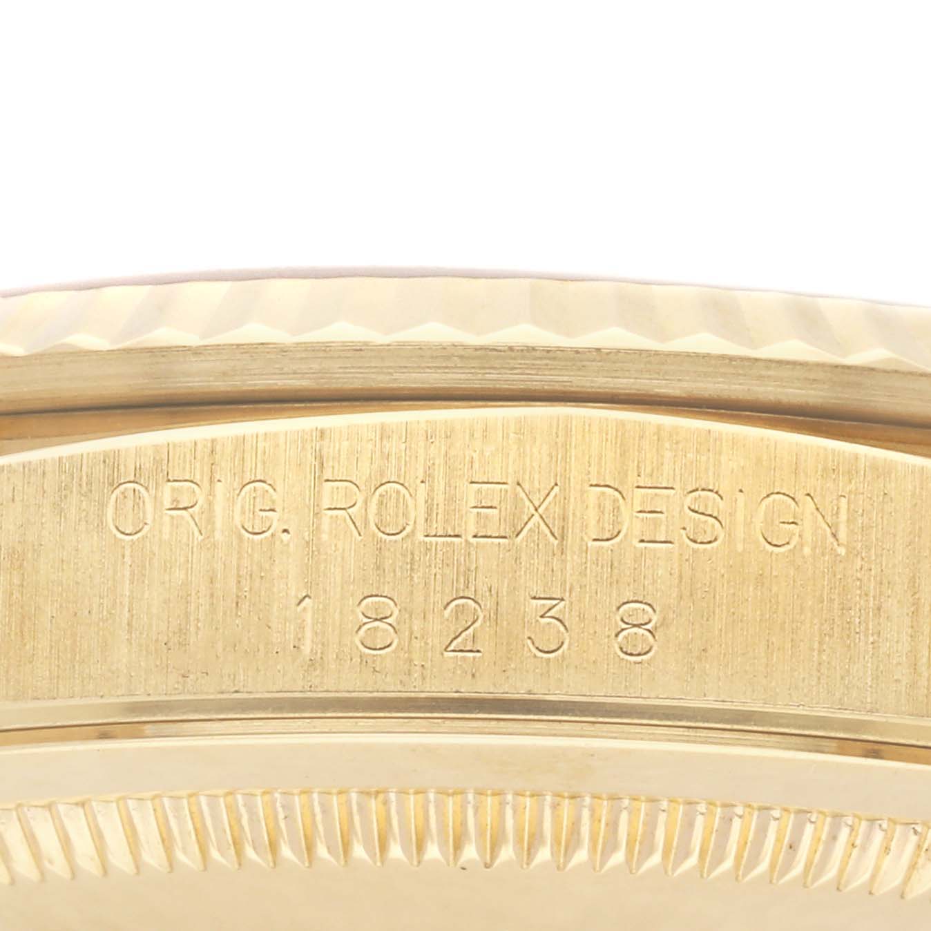 The image shows the engraved side of a Rolex President 18238 Men
s Yellow Gold Champagne Dial 18238 Men
s Yellow Gold Champagne Dial model with the serial and design numbers visible.