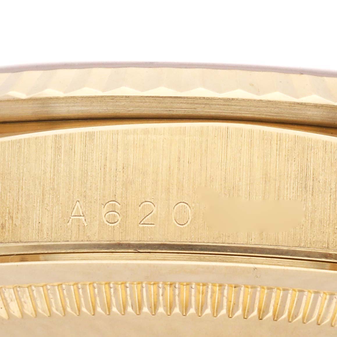 The image shows a close-up of the gold side edge and engraved serial area of a Rolex President 18238 Men
s Yellow Gold Champagne Dial 18238 Men
s Yellow Gold Champagne Dial watch.